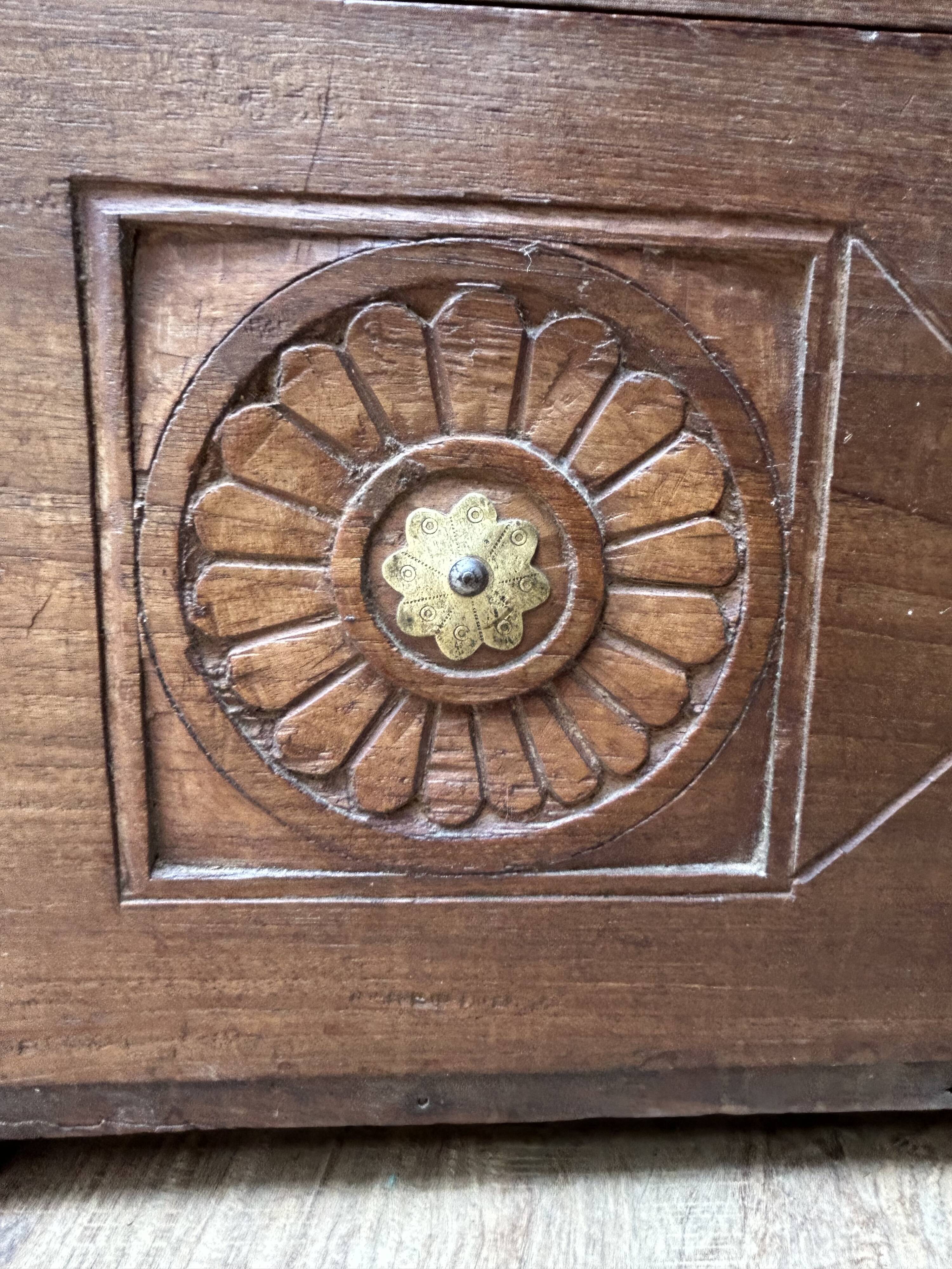 Teak chest from Burma with carved rosettes.