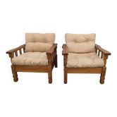Pair of cosy mountain-style armchairs with vintage chalet pine design.
