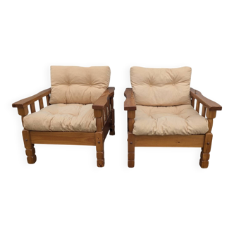 Pair of cosy vintage design mountain style armchairs in pine chalet.