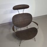 Armchair designed by Yuzuru Yamakawa  Metal frame.  Seat and back in braided rattan.