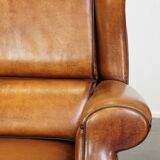 Set of 2 very comfortable large sheepskin armchairs elegantly finished with black piping