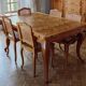 Carved wooden dining table and its 5 rattan caned chairs.