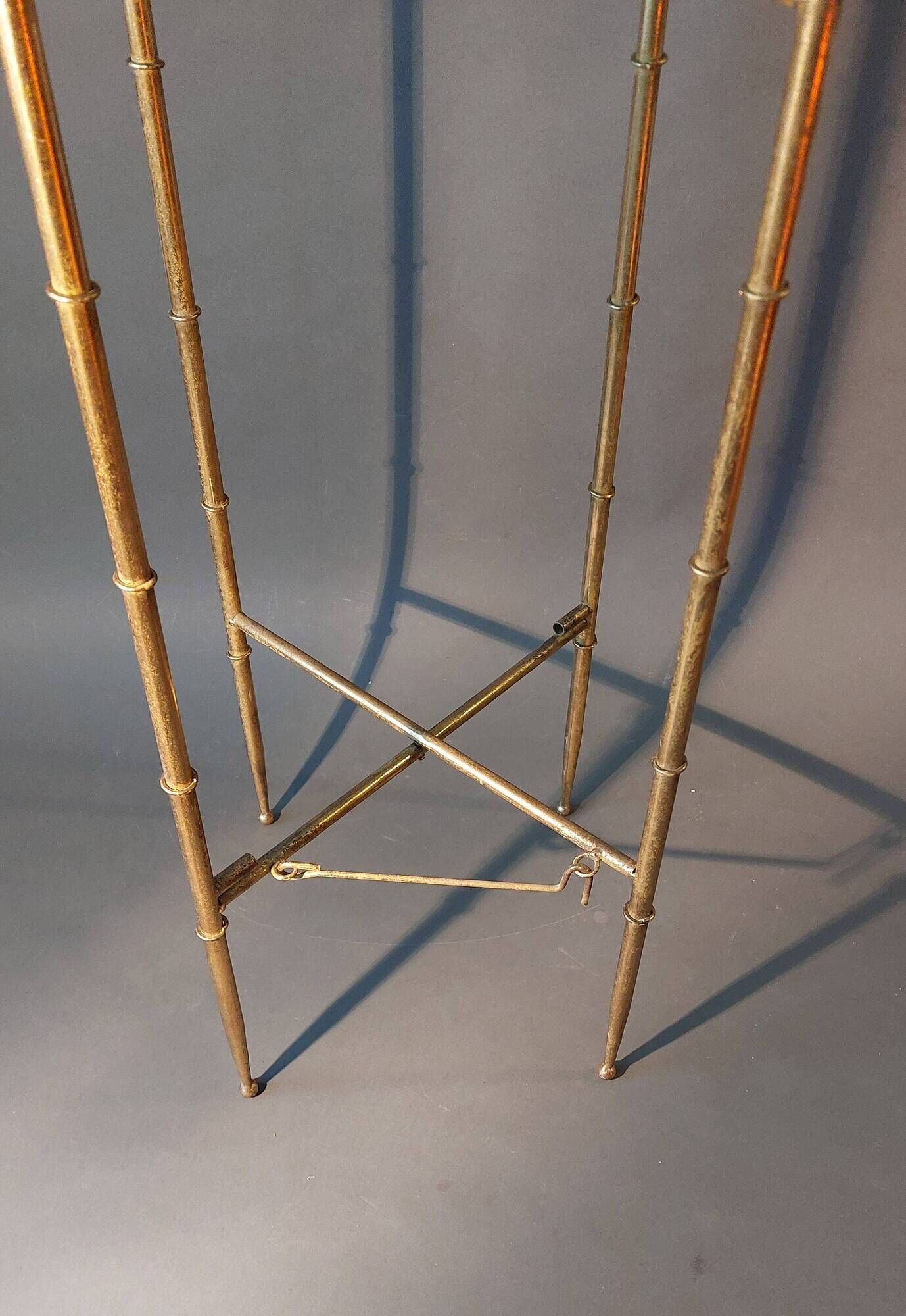 Pedestal table in patinated gilded brass faux foldable bamboo.