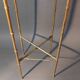Pedestal table in patinated gilded brass faux foldable bamboo.