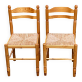 2 straw-seated chairs in light-colored solid wood