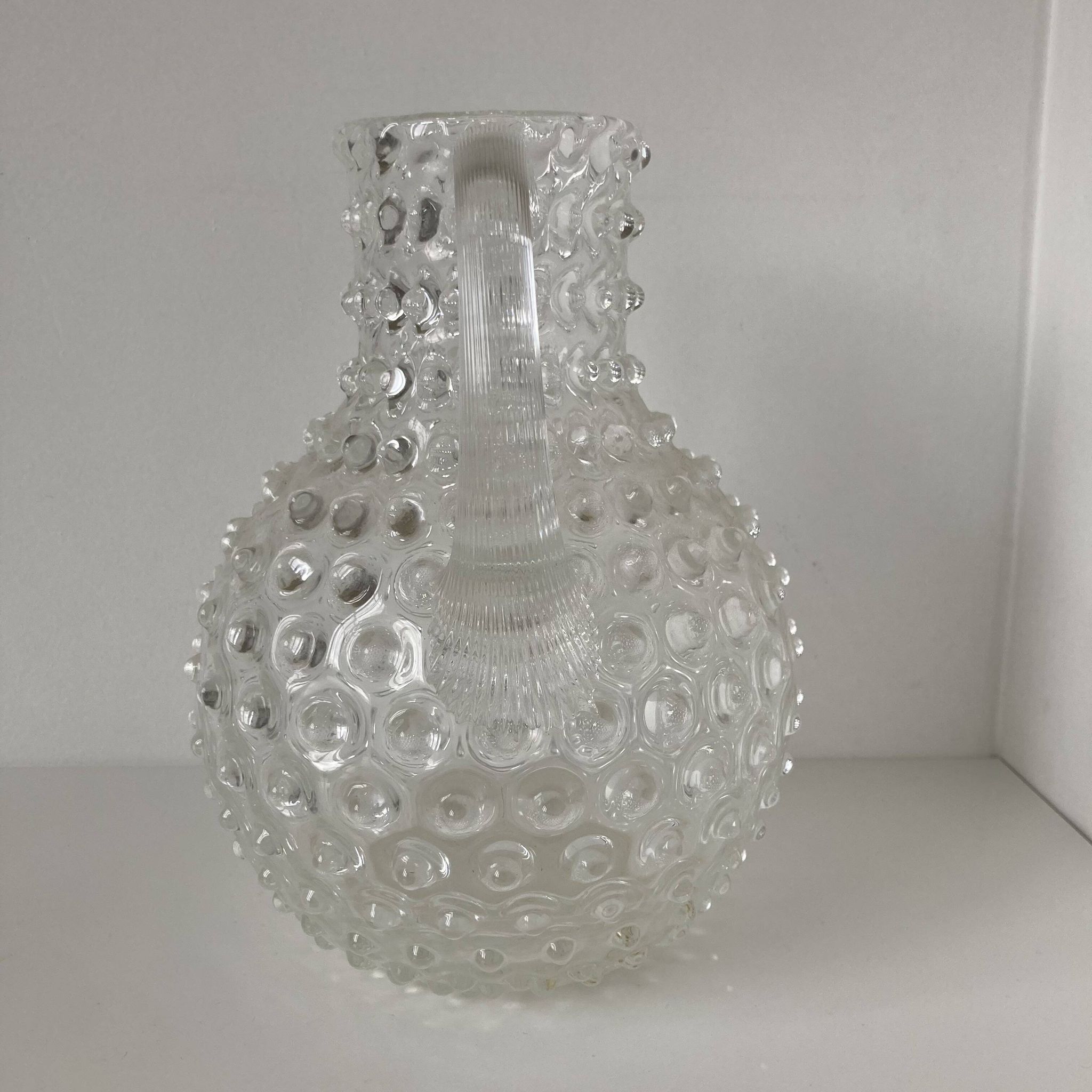 Beautiful and large vintage glass jug with a handle, made of clear hot-worked glass.