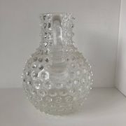 Beautiful and large vintage glass jug with a handle, made of clear hot-worked glass.