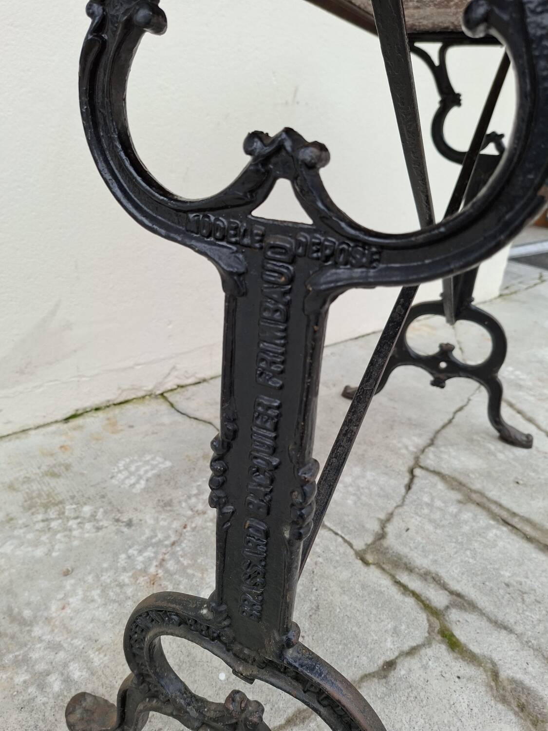 Solid oak bistro table with a cast iron base, signed.