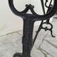 Solid oak bistro table with a cast iron base, signed.