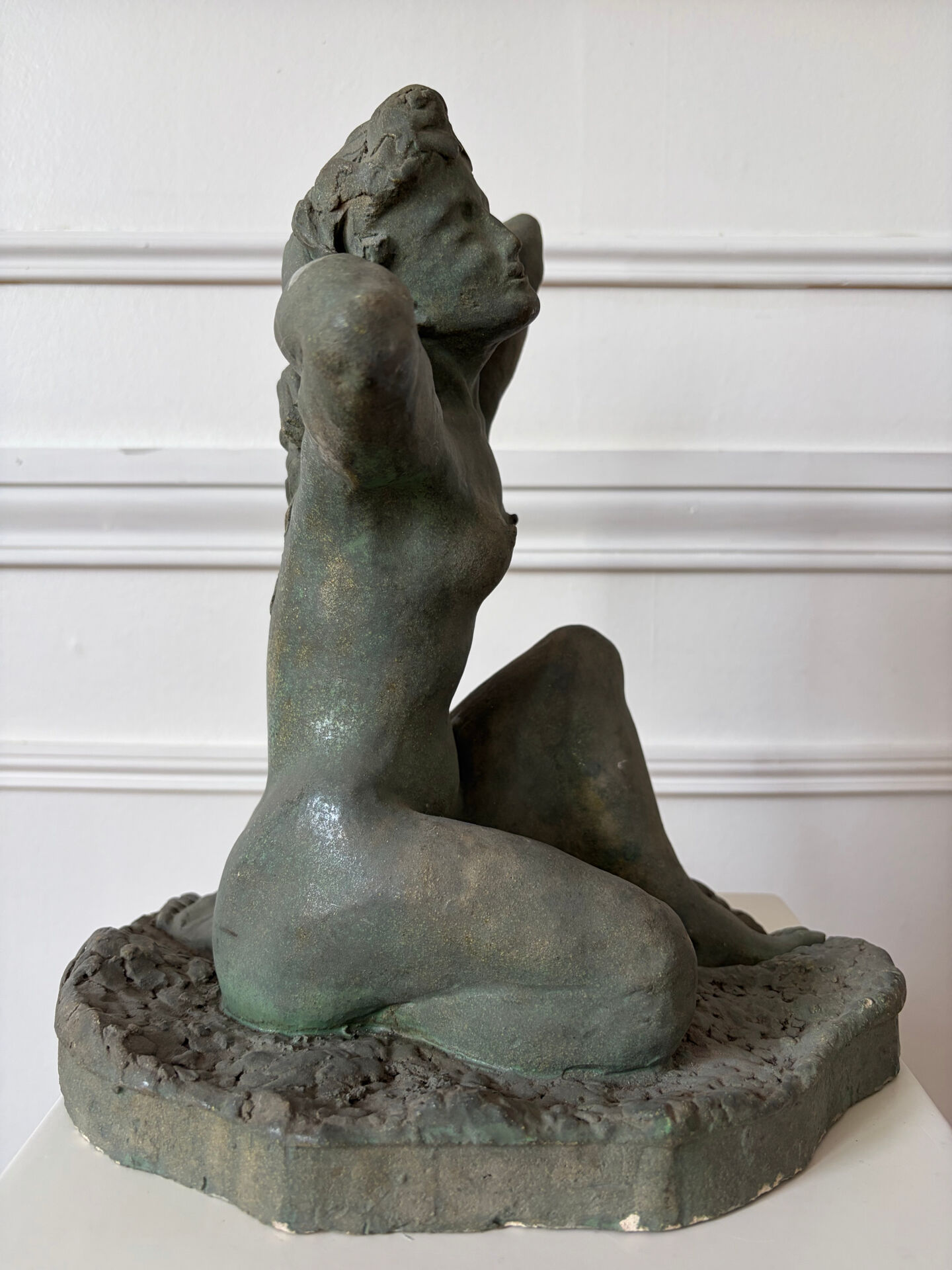 Sculpture of a naked woman titled "Youth" in terracotta.