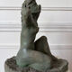 Sculpture of a naked woman titled "Youth" in terracotta.