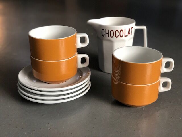 Hot chocolate cups and milk jar