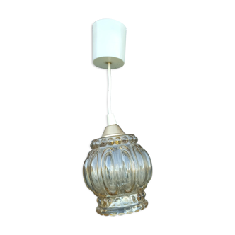 Suspension in molded glass golden reflection