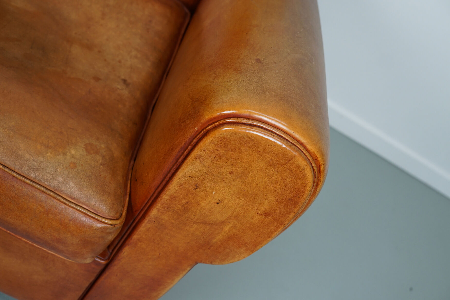 Vintage french moustache back cognac-colored leather club chair