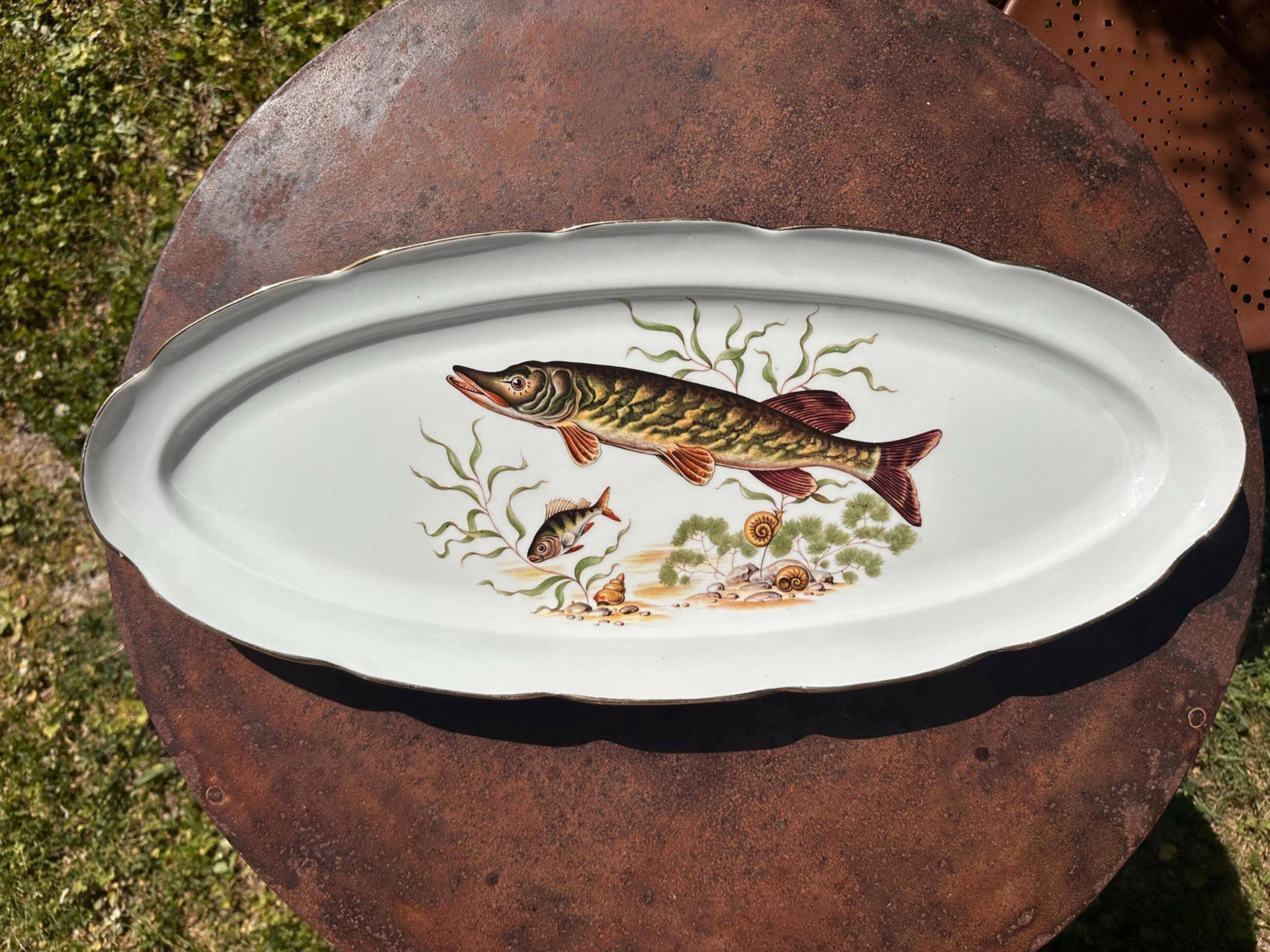 Large fish platter and its vintage porcelain sauce boat, decorated with pike.