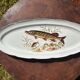 Large fish platter and its vintage porcelain sauce boat, decorated with pike.