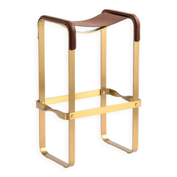 Bar stool in aged brass and brown leather.