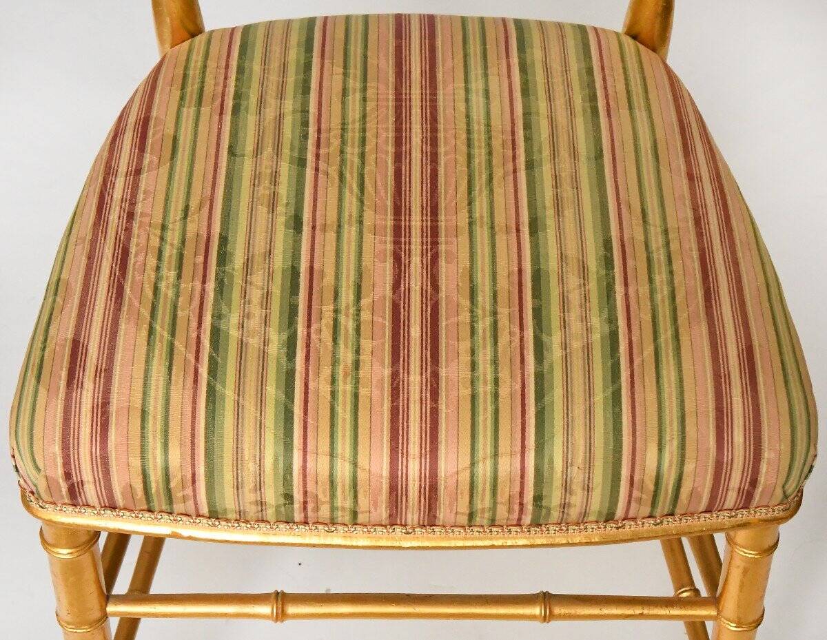 Pair of golden wood chairs in a bamboo style.