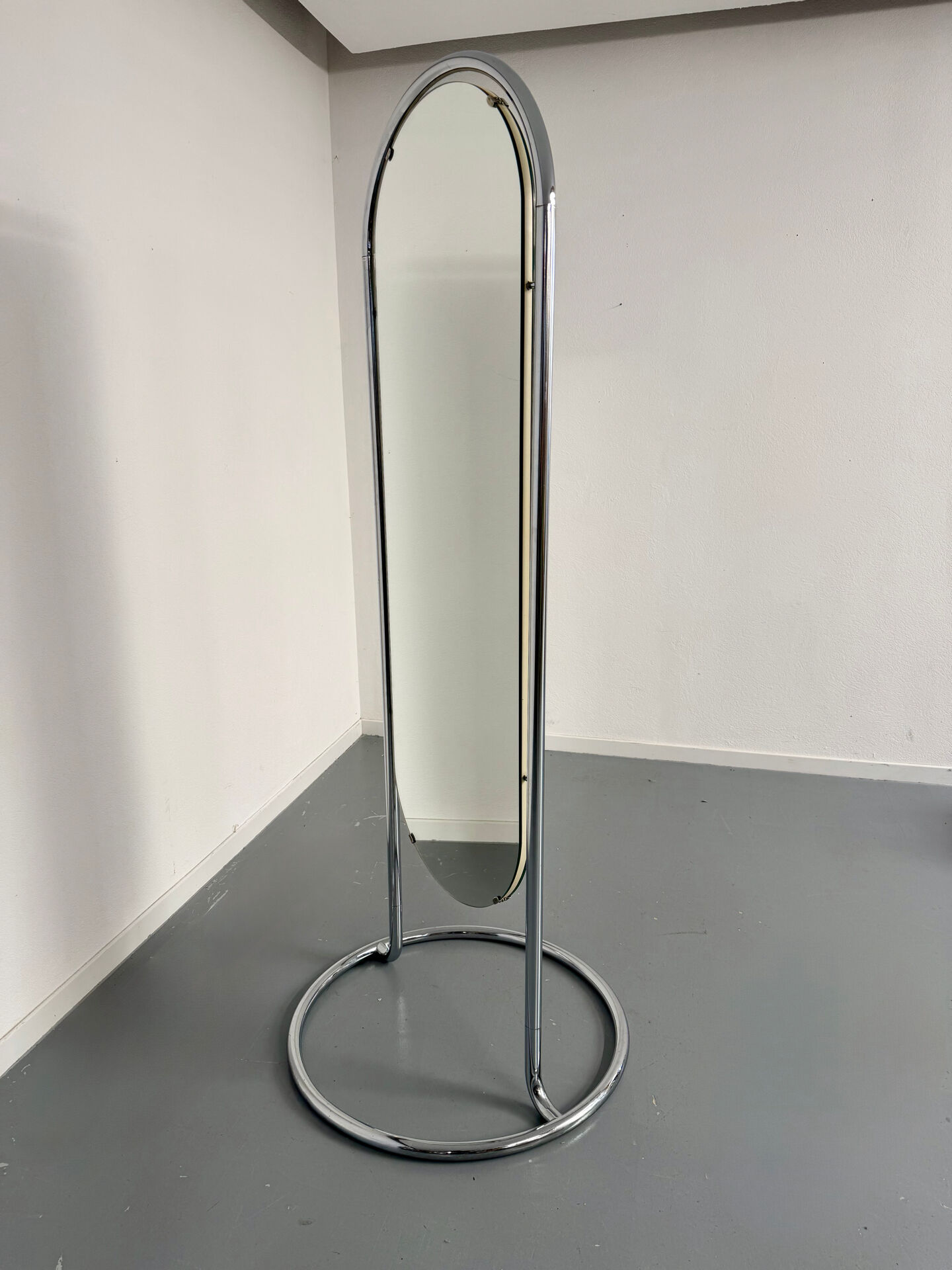 Large freestanding chrome metal full-length mirror in 1970s design.