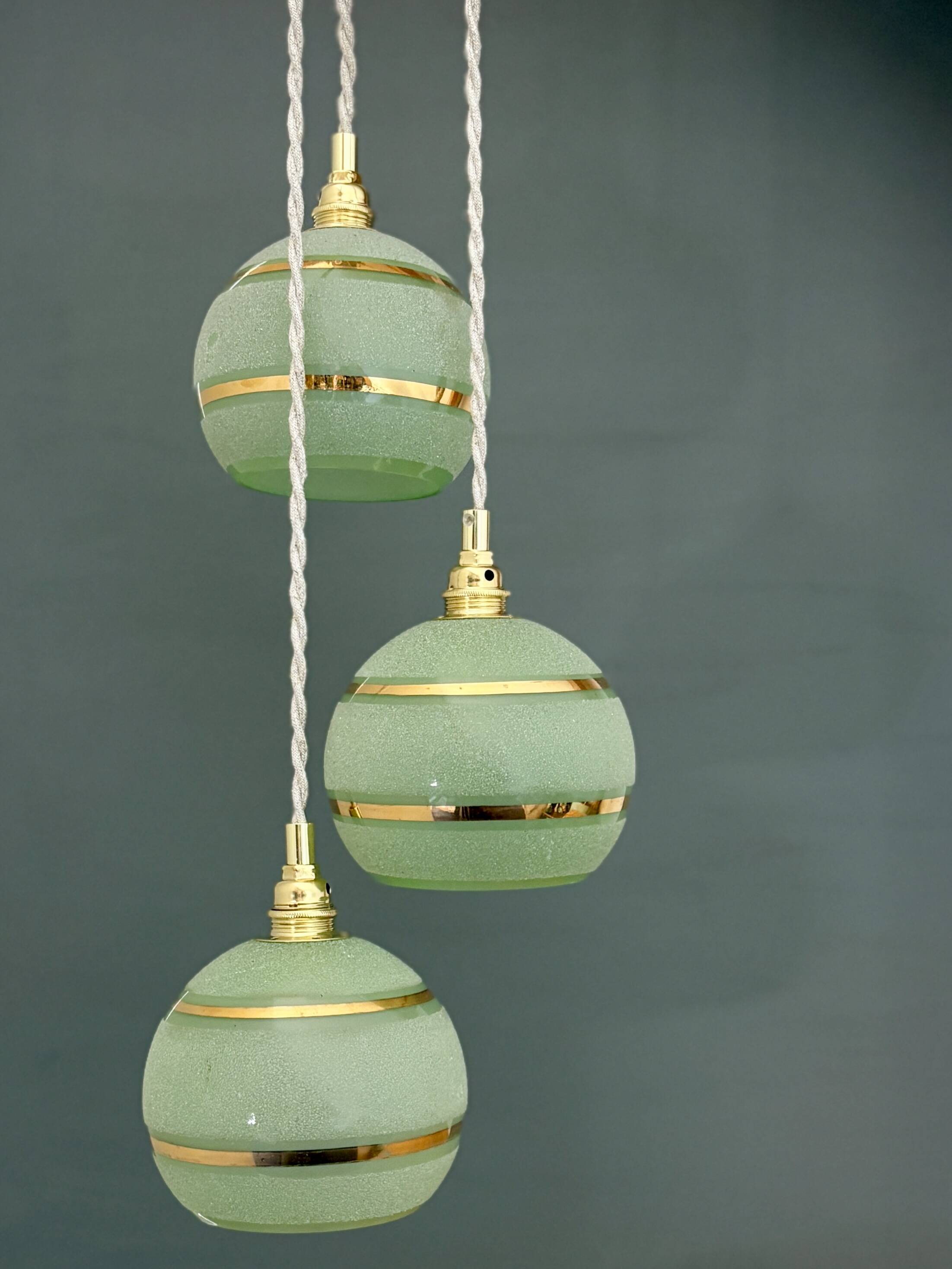 Suspension triple vintage glass globes in frosted green and gold.