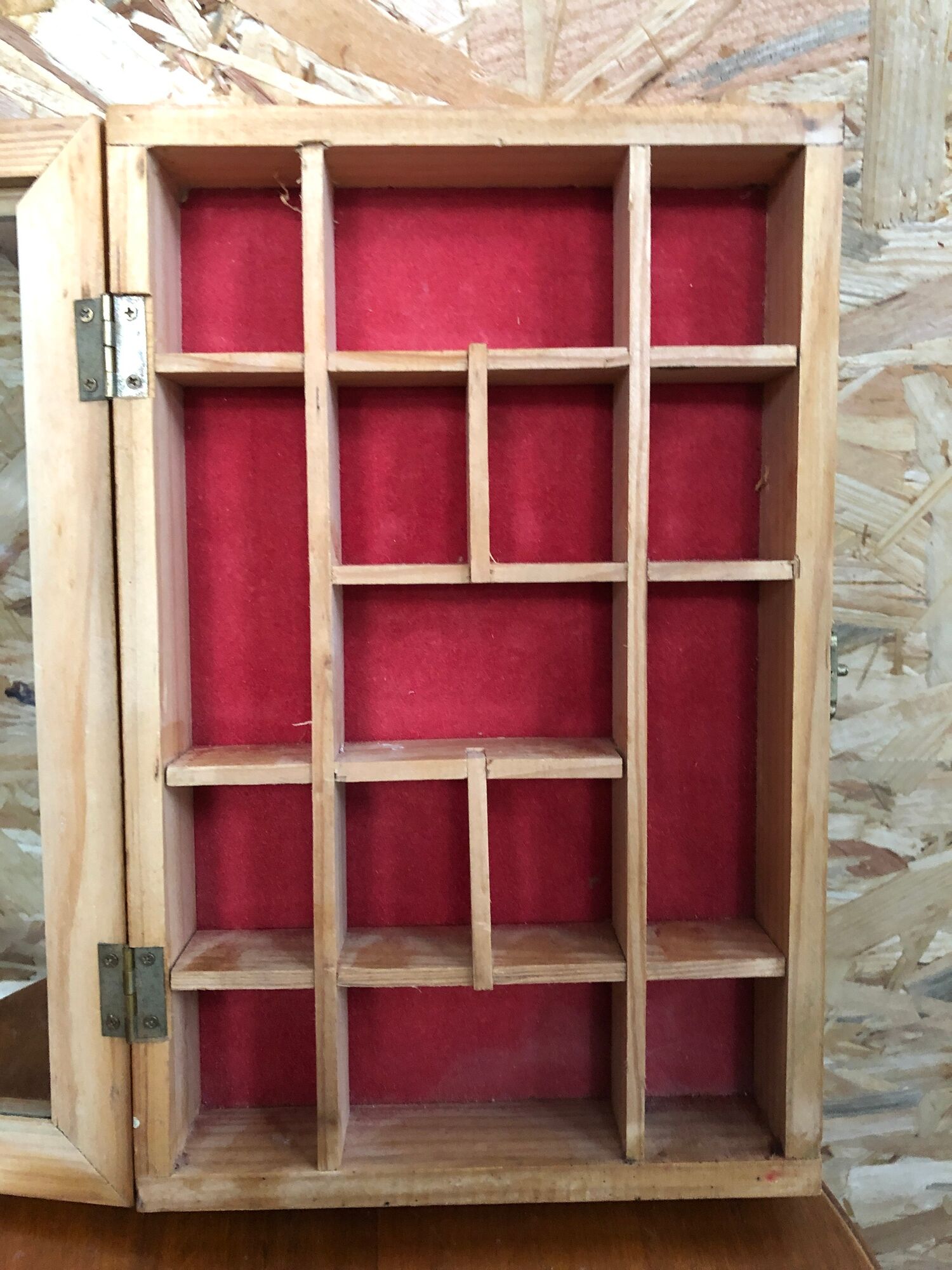 Old hanging display case with 15 wooden boxes, red background + vintage glass door