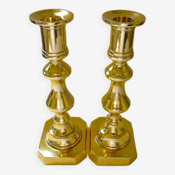 Pair of bronze torches with natural patina on a rectangular base