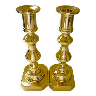 Pair of bronze torches with natural patina on a rectangular base