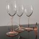 4 Luminarc white wine glasses with pink feet