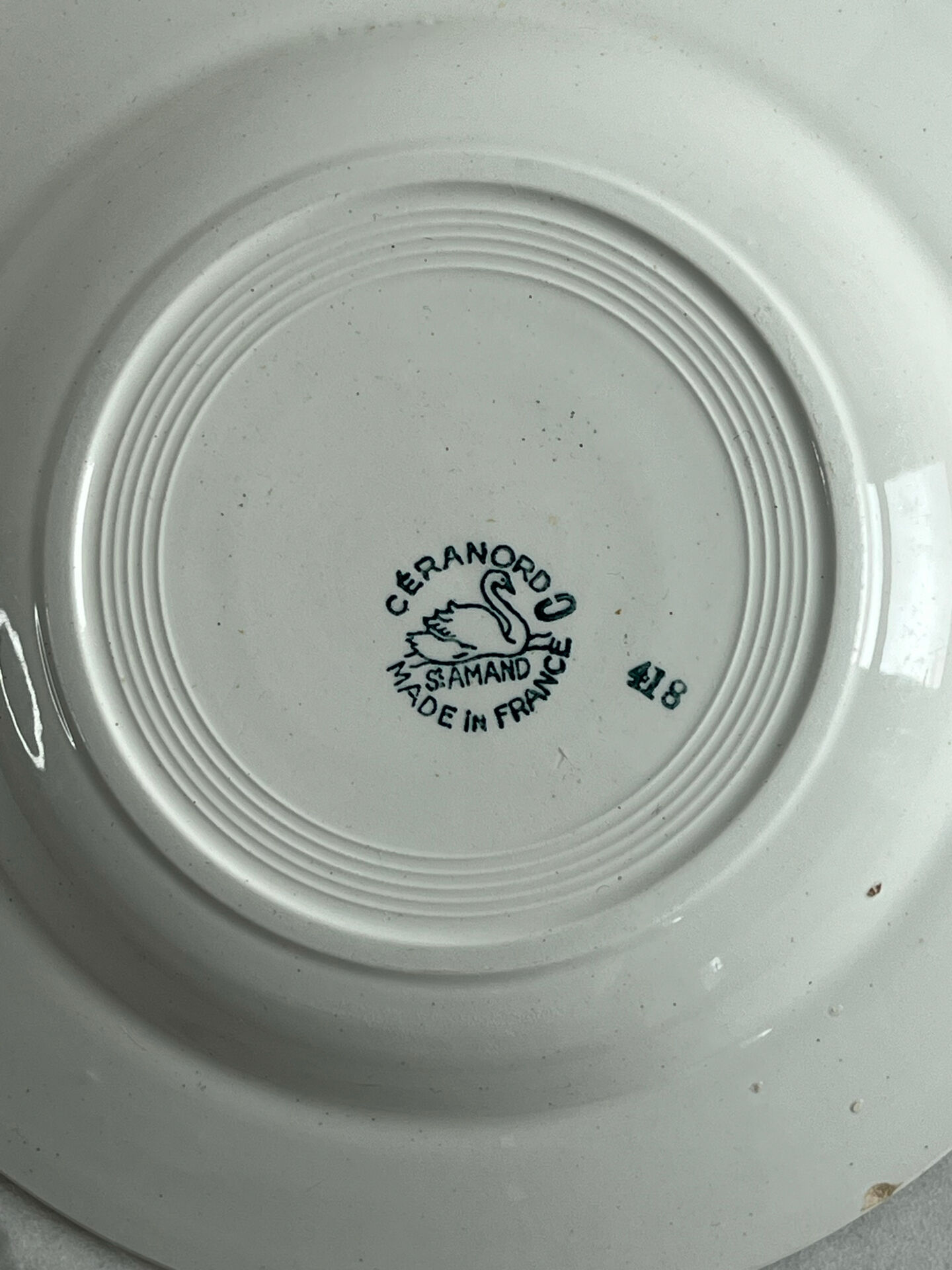 Céranord Saint Amand deep plate with green crown decoration.