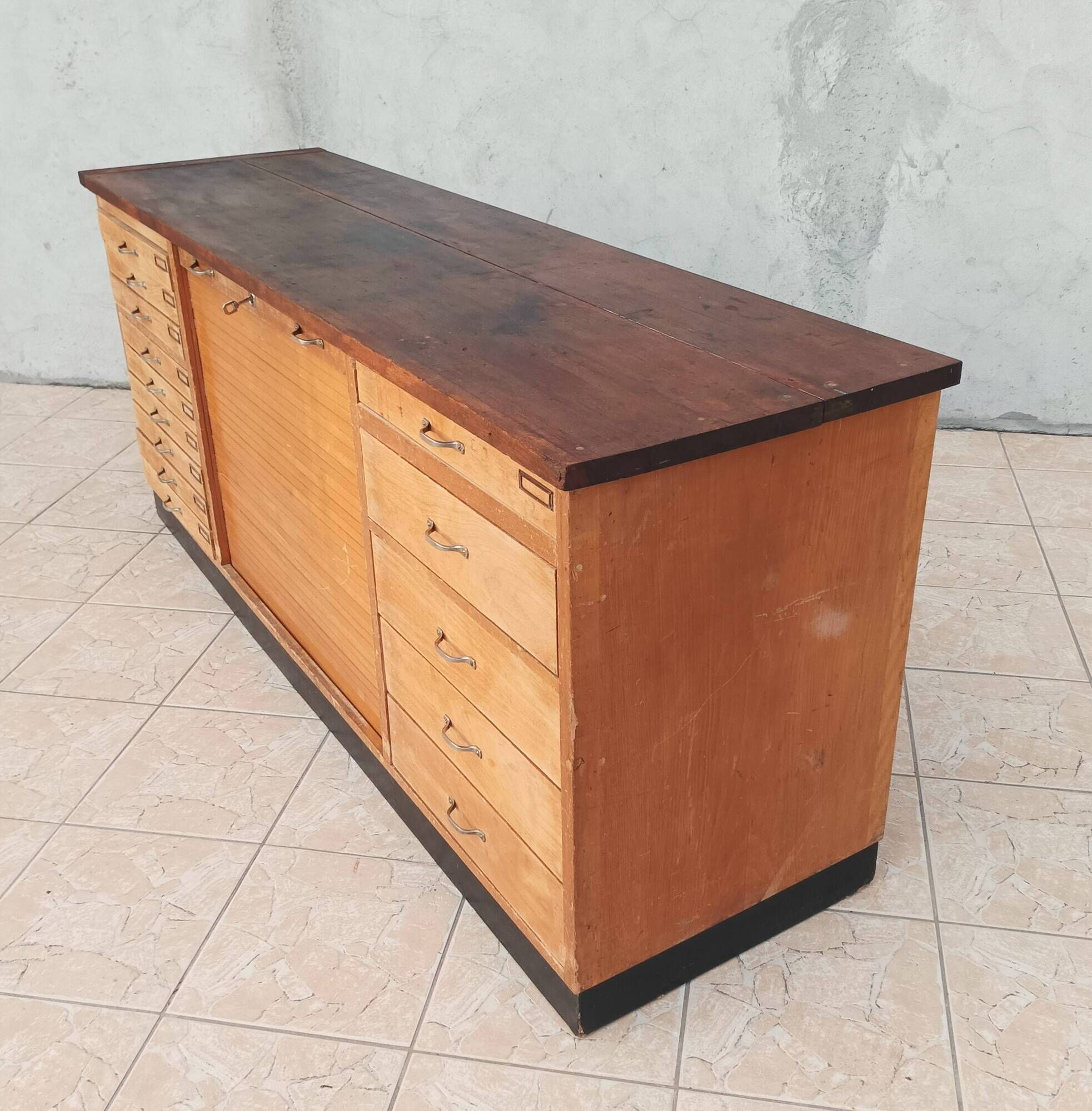 Workshop furniture with drawers and curtain in beech and walnut.
