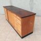 Workshop furniture with drawers and curtain in beech and walnut.