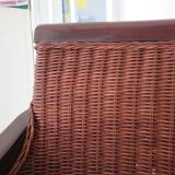 Vintage colonial-style armchair in woven rattan and exotic wood