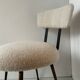 Low seat in metal and white boucle fabric.