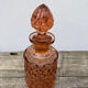 Art Deco perfume bottle in old amber pink glass