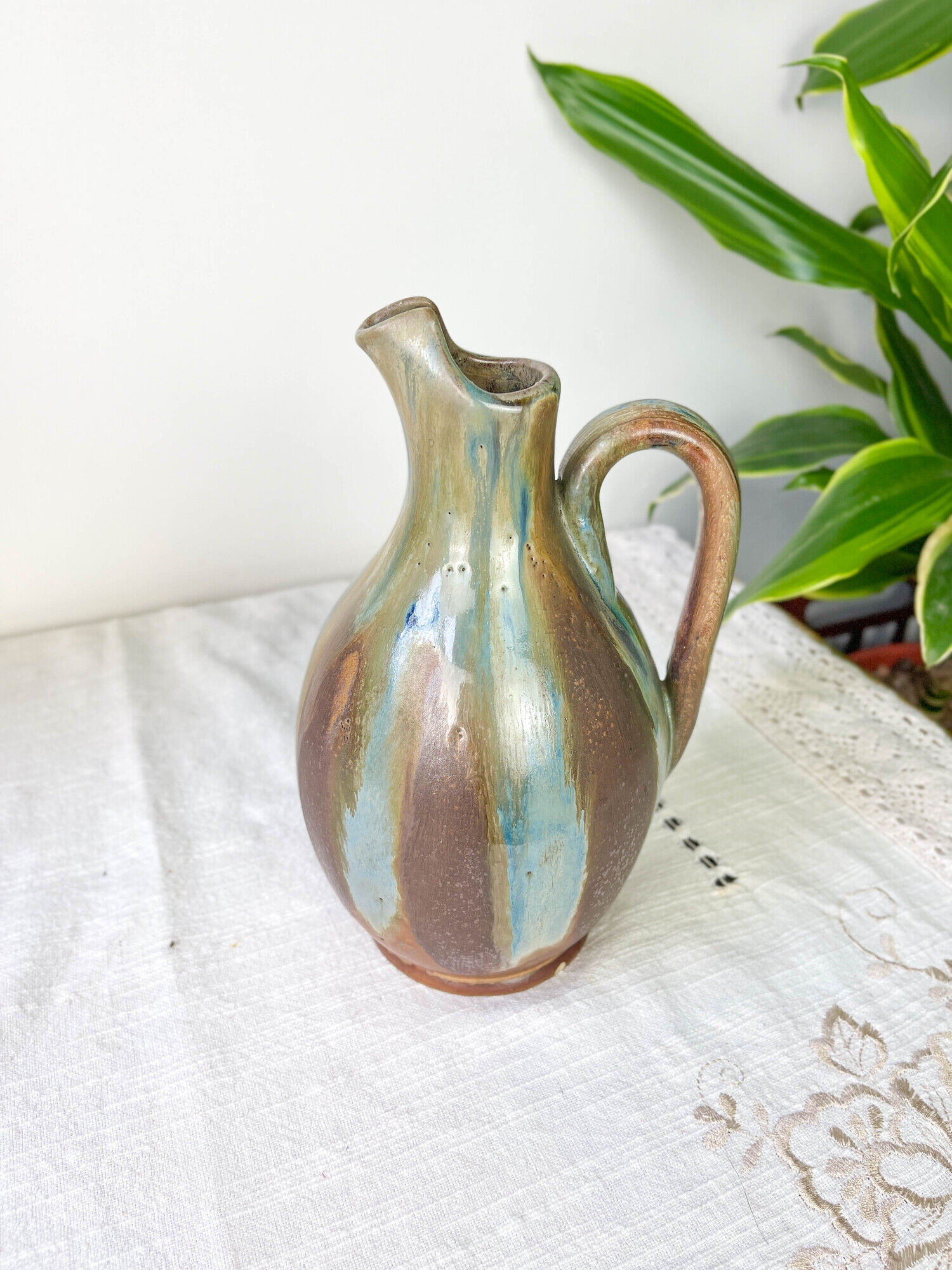 Art Nouveau style carafe in flamed stoneware with blue and brown drips