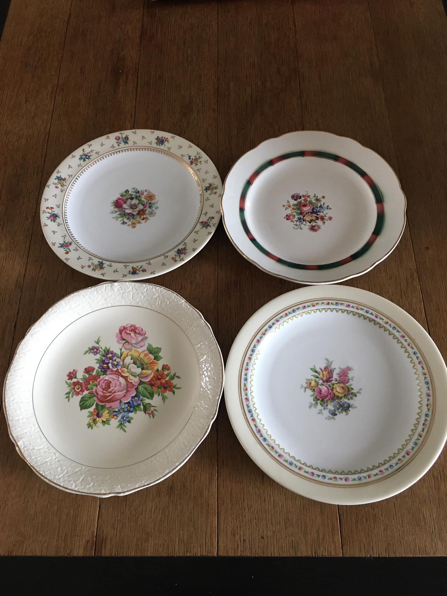 4 mismatched flat plates with floral patterns. Porcelain. Stamped