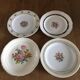 4 mismatched flat plates with floral patterns. Porcelain. Stamped