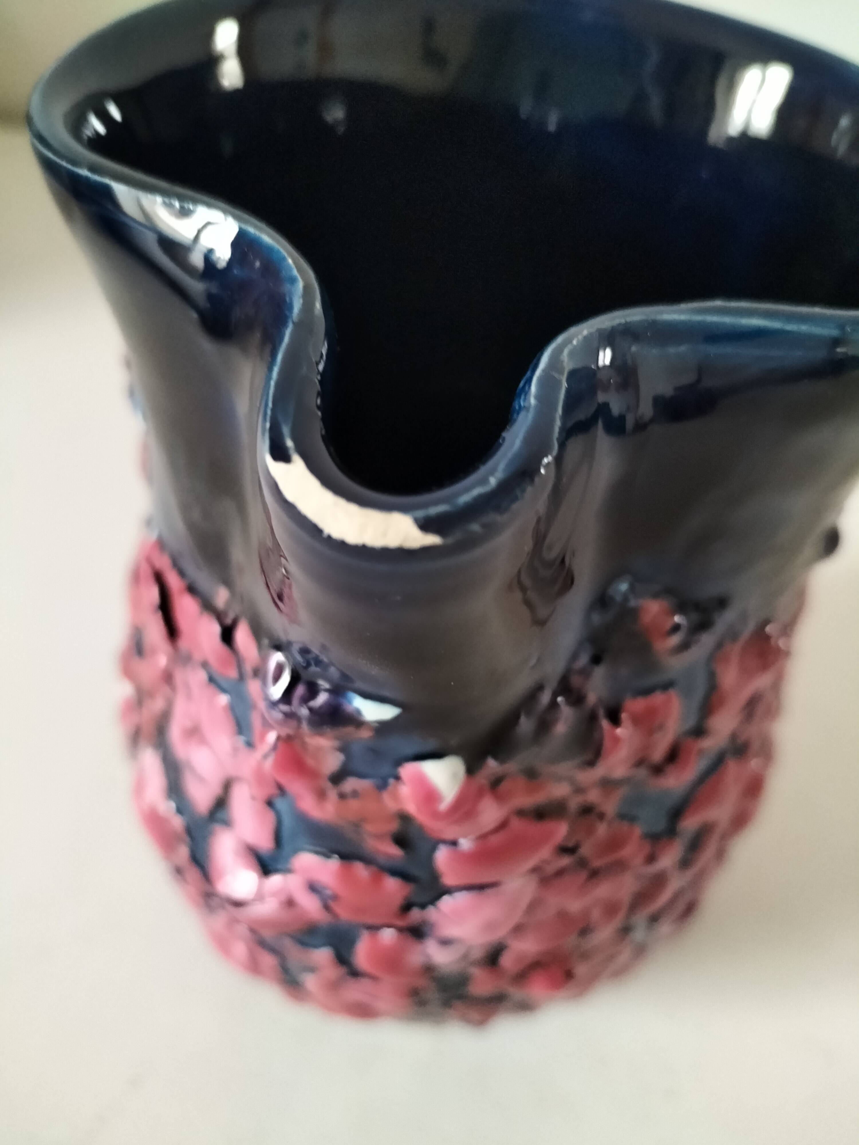 Vintage pitcher in midnight blue glazed ceramic with bright pink relief