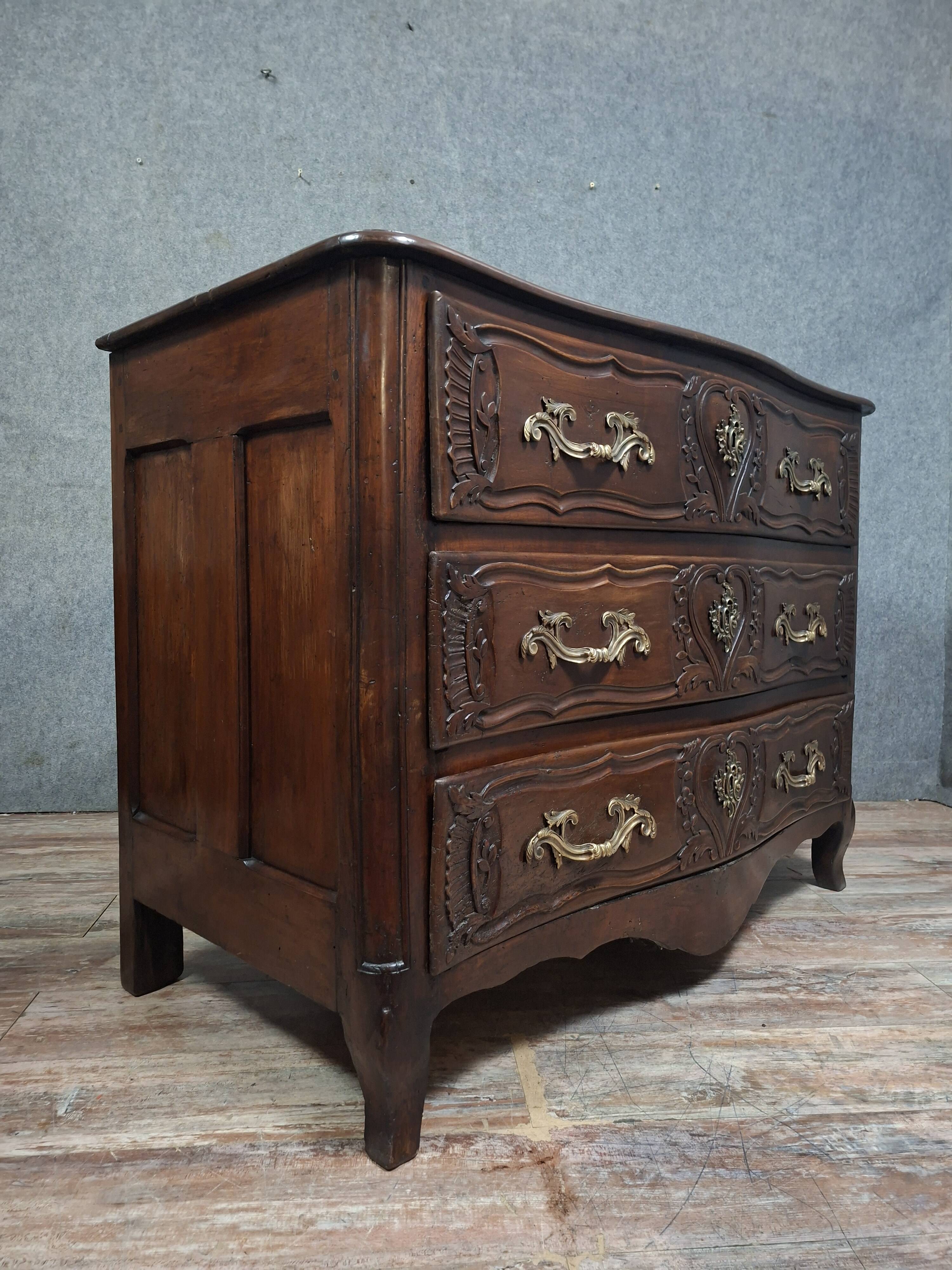 Louis XV/XVIII period Lyonnaise commode in moulded and carved walnut.