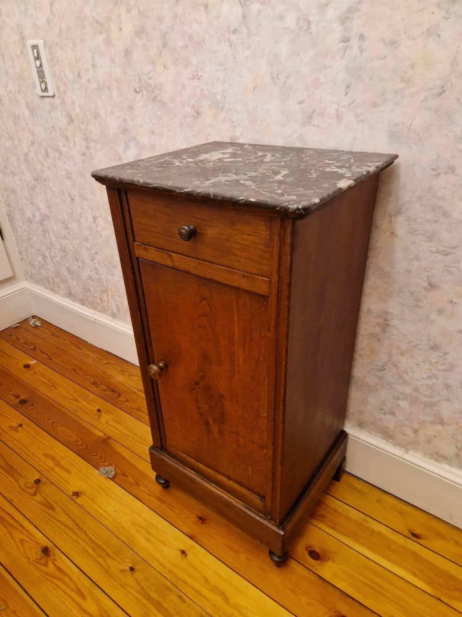 Antique wooden bedside table with black marble top