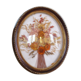 Medallion of dried flowers with a domed frame