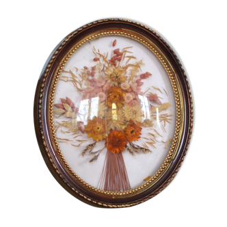 Medallion of dried flowers with a domed frame