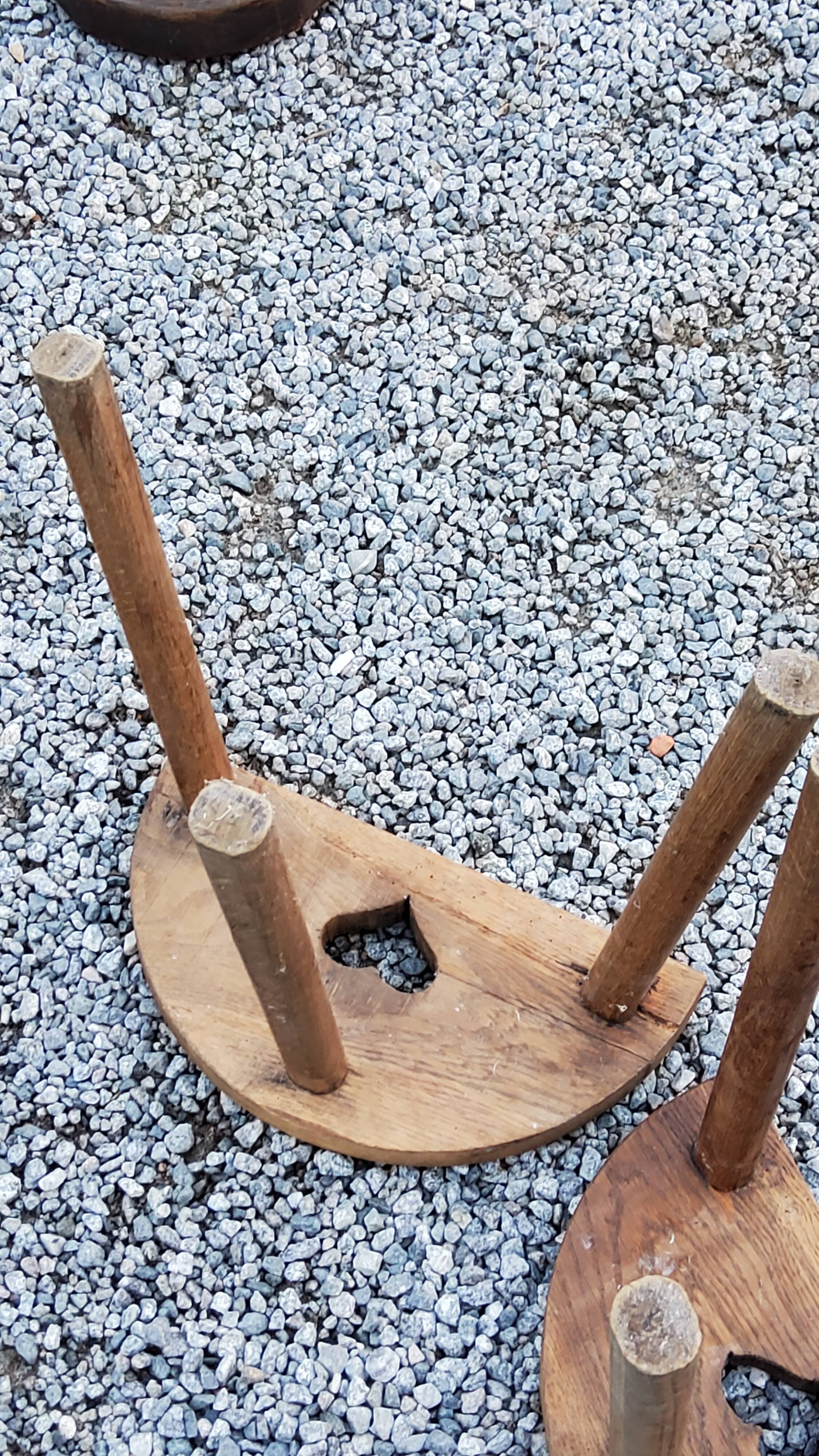 Pair of shepherd's stools in tripod oak décor in the heart