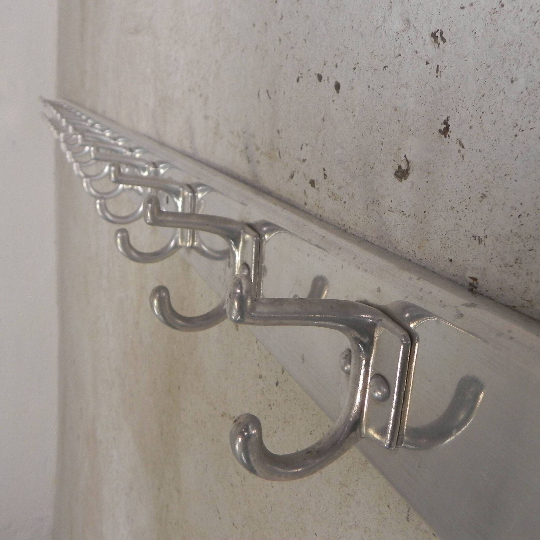 Wall-mounted aluminium coat rack of 225 cm with 16 double hooks, 1960s.