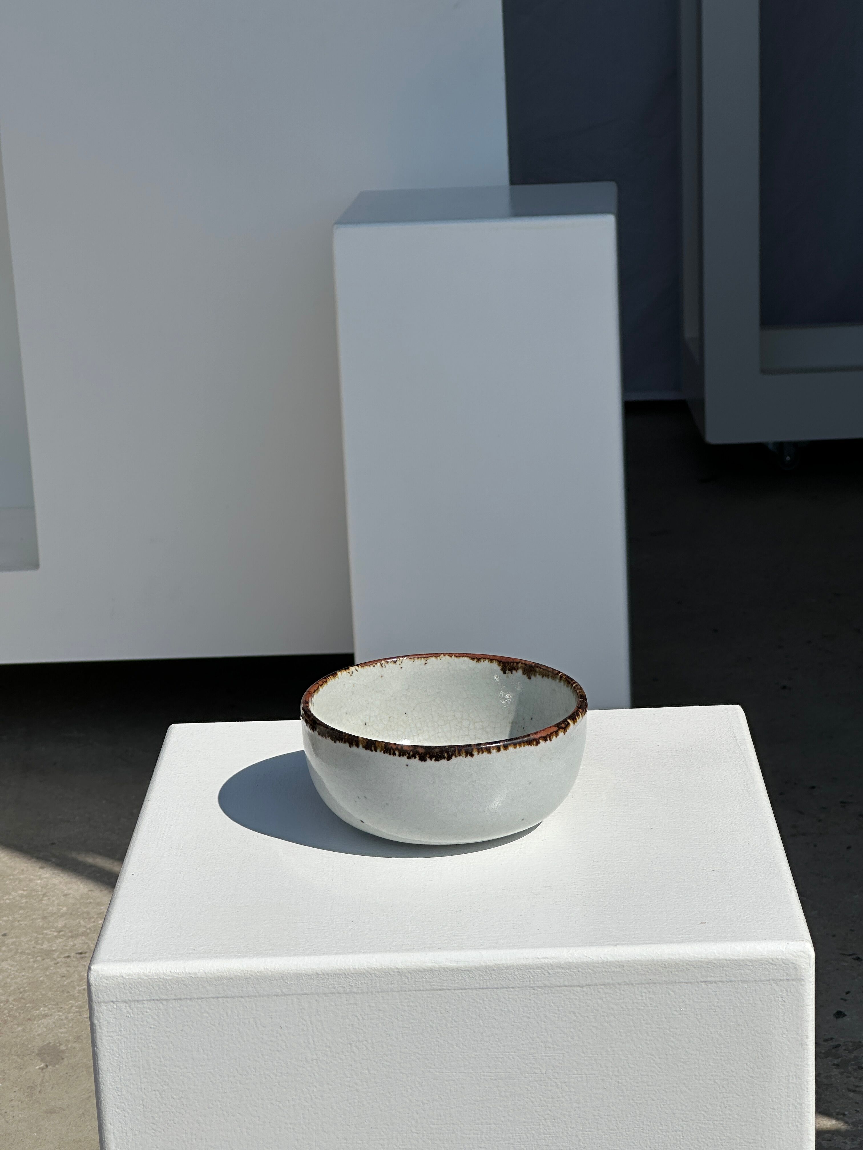 Small white glazed ceramic bowl black edges