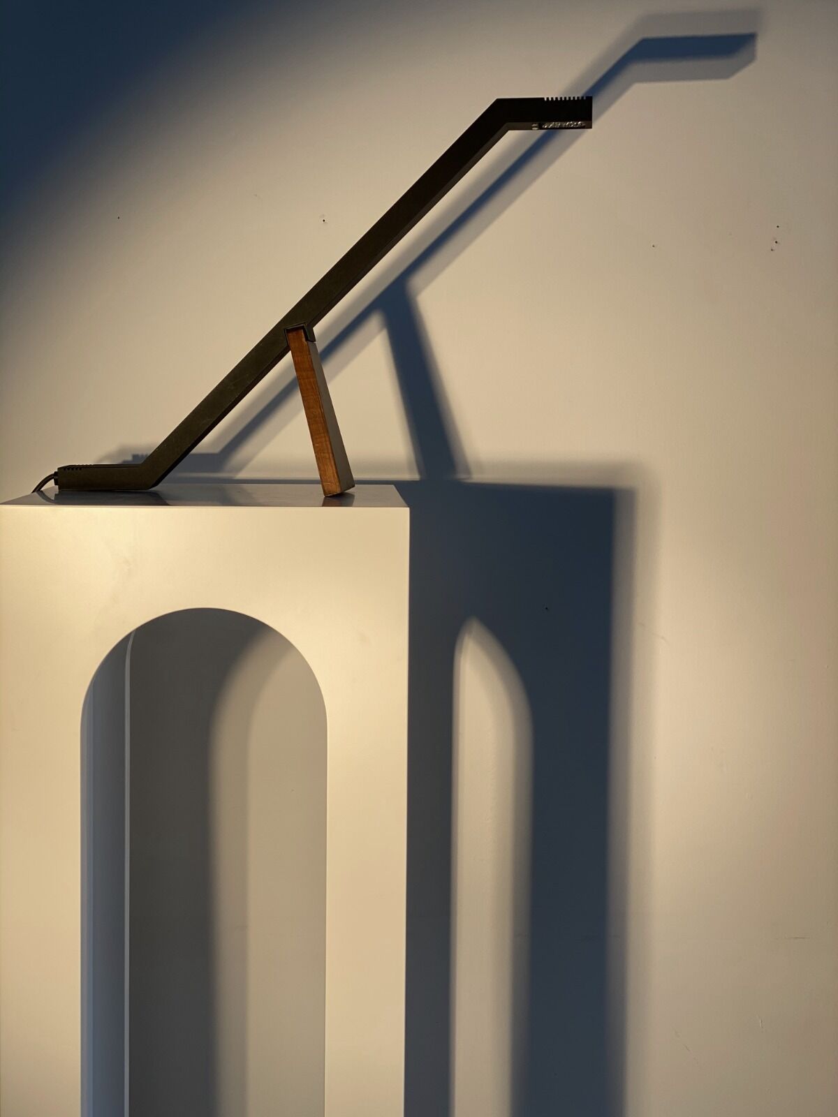 Black solid monoxyl wood bench carved into 3 arches