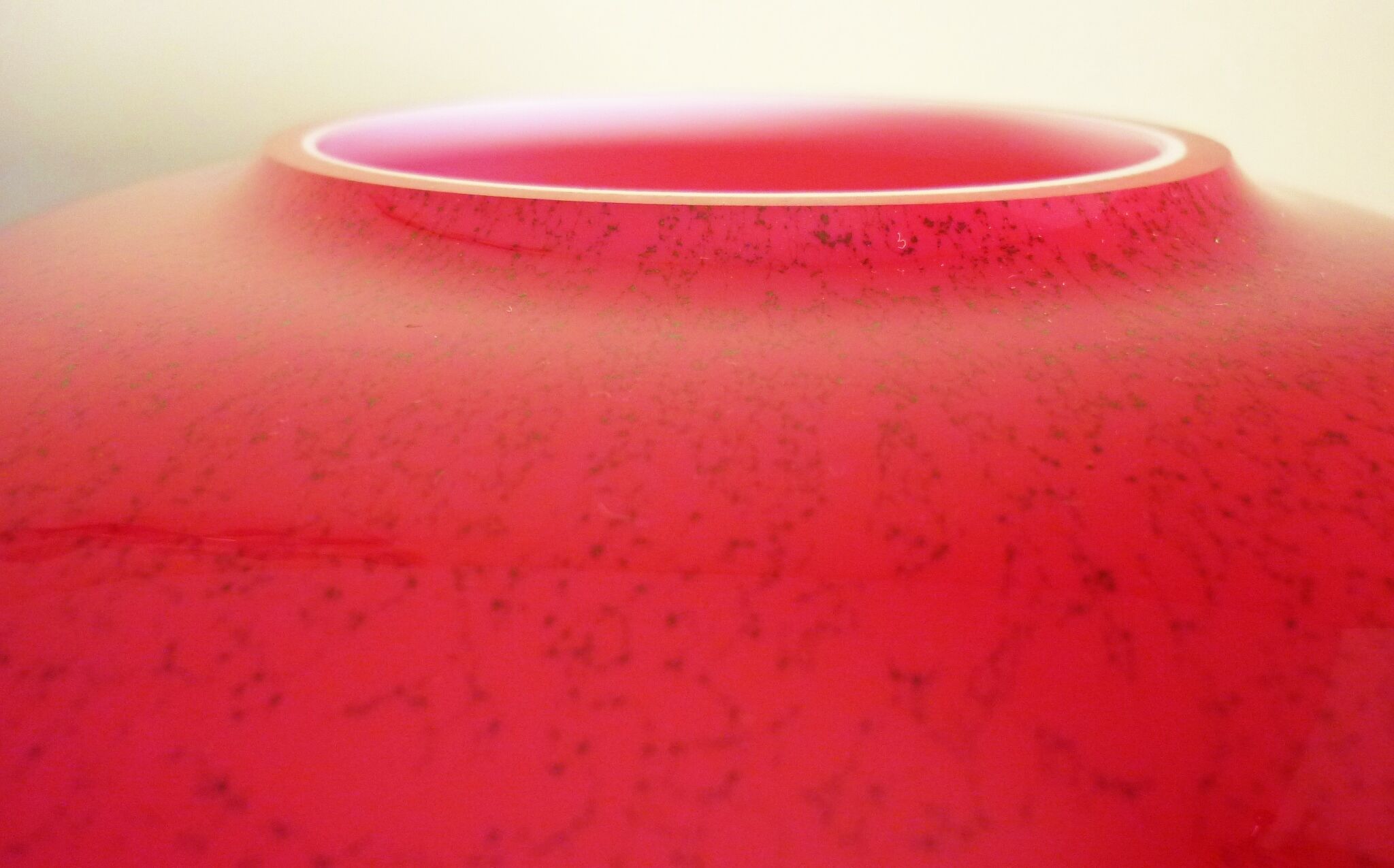 Pot-bellied, art deco vase in speckled ruby red multi-layered glass, white interior