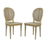 Pair of white canne and lay chairs