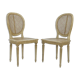 Pair of white canne and lay chairs