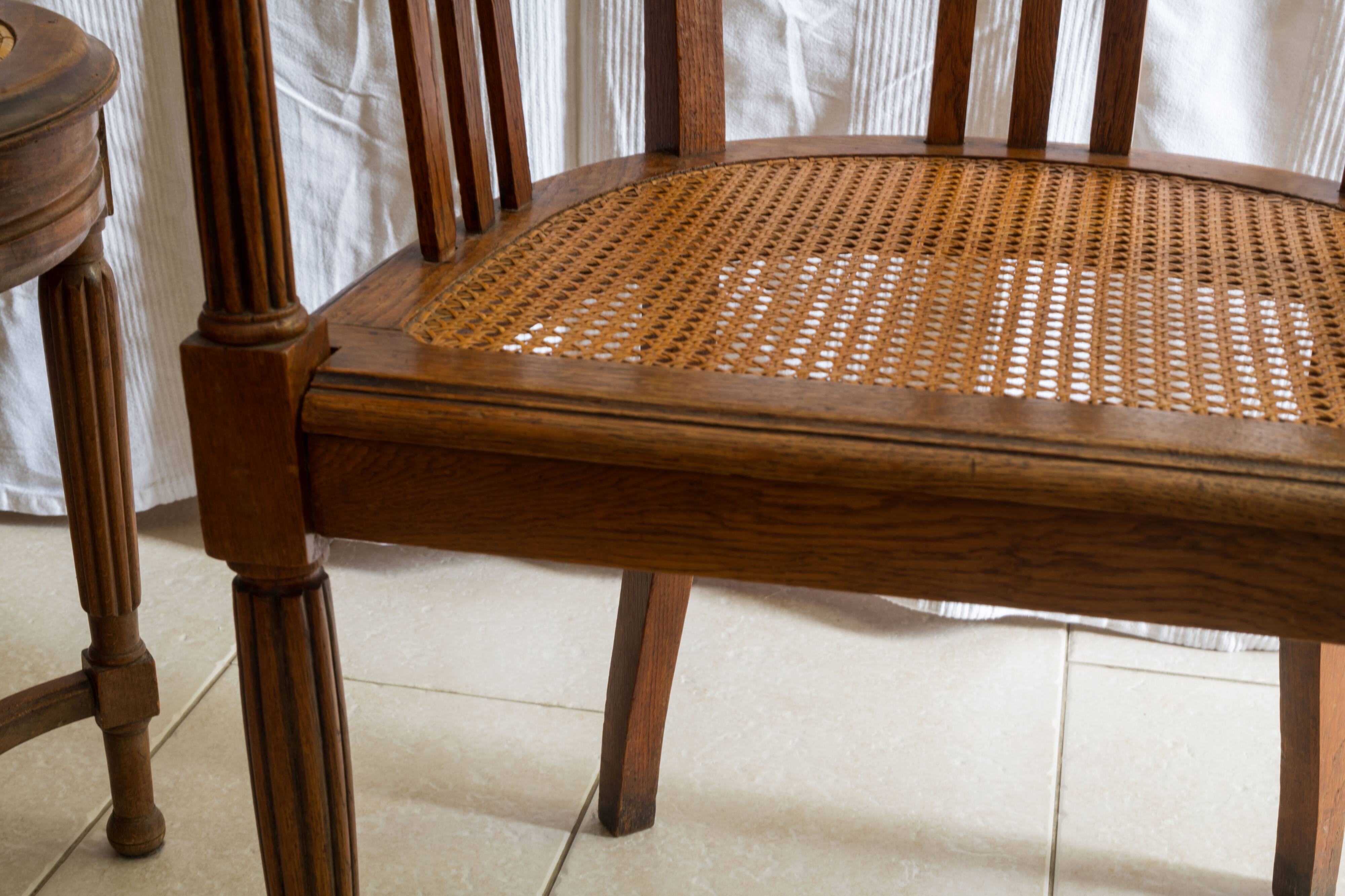 Antique armchair and stool with caned seat and fluted legs